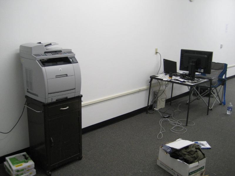 kevin&rsquo;s desk at drywall lane office next to lonely printer