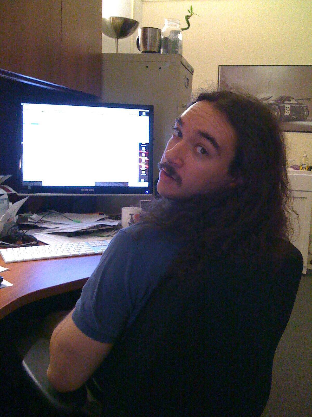 matt looking suave at his desk with long hair