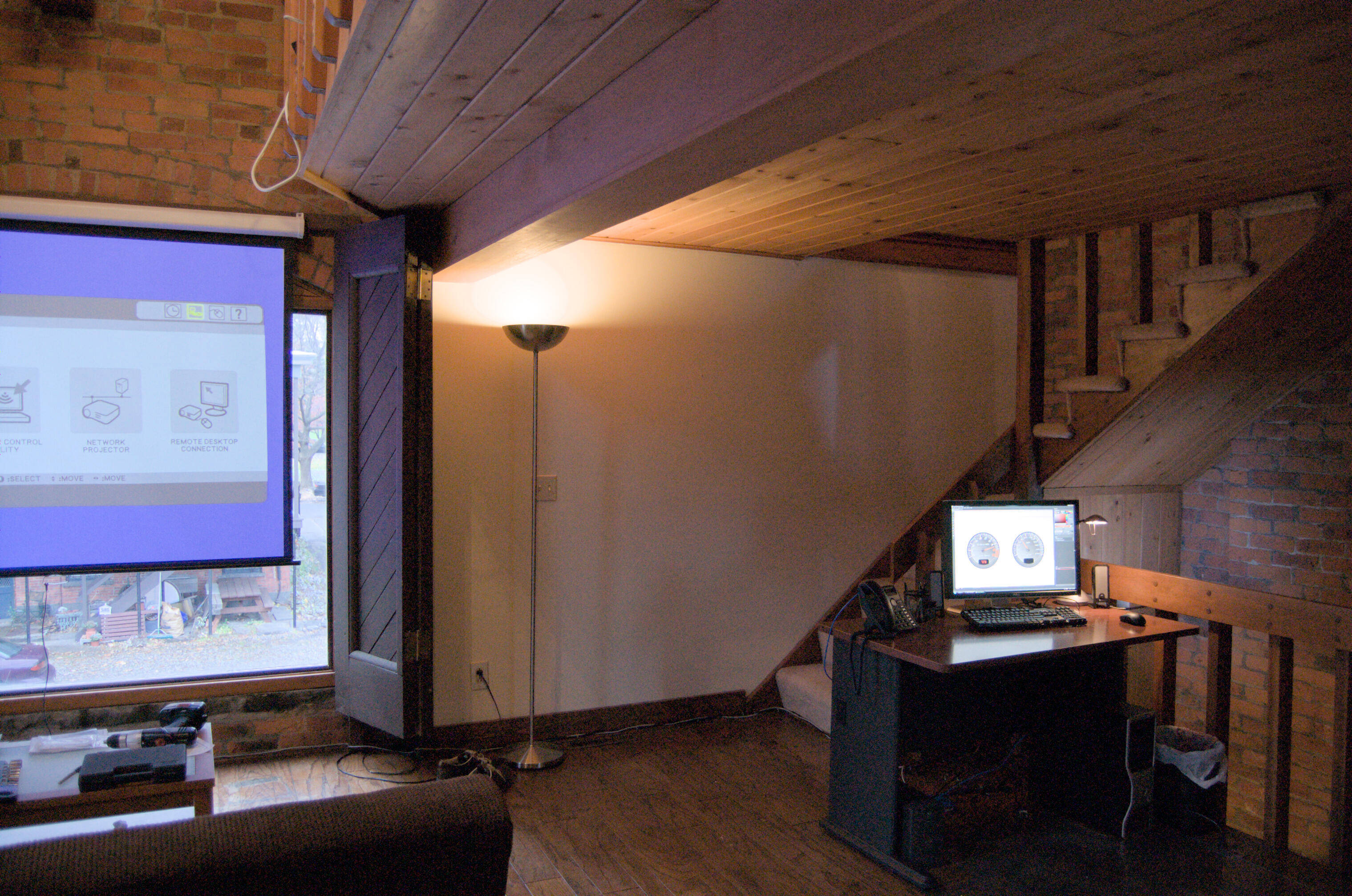 projector, main window, desk and stairs up to 3rd floor loft in willett house