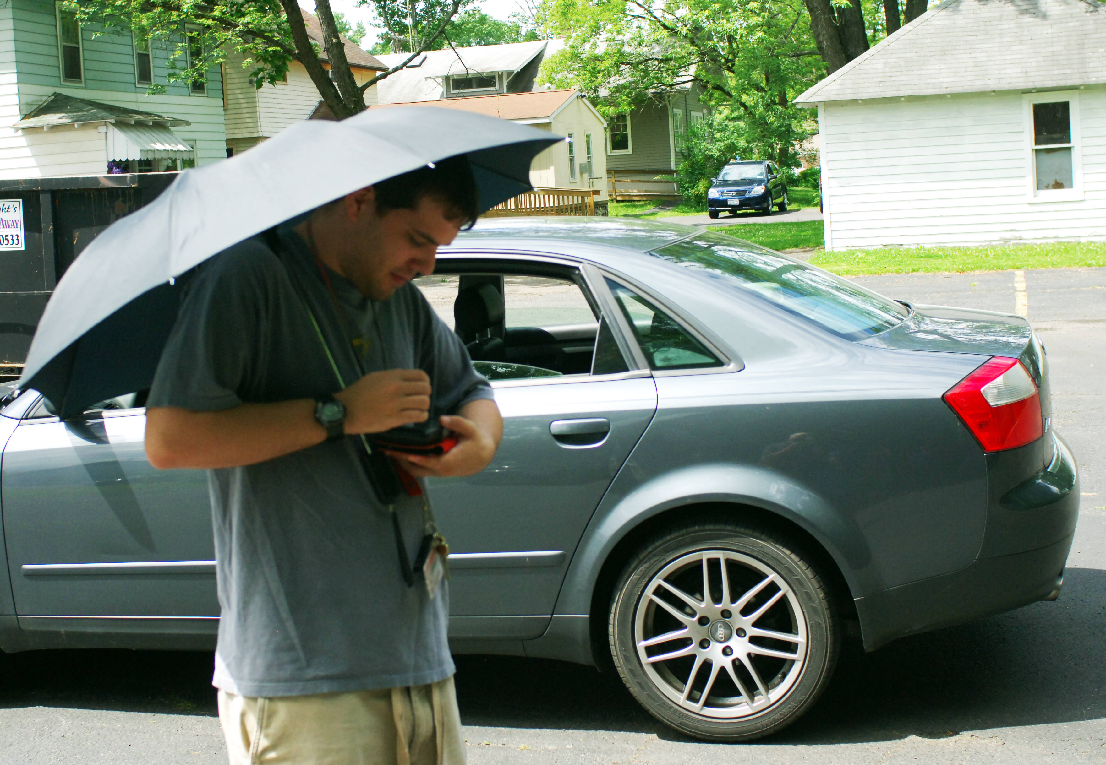 jeff with prototype outside car holding umbrella