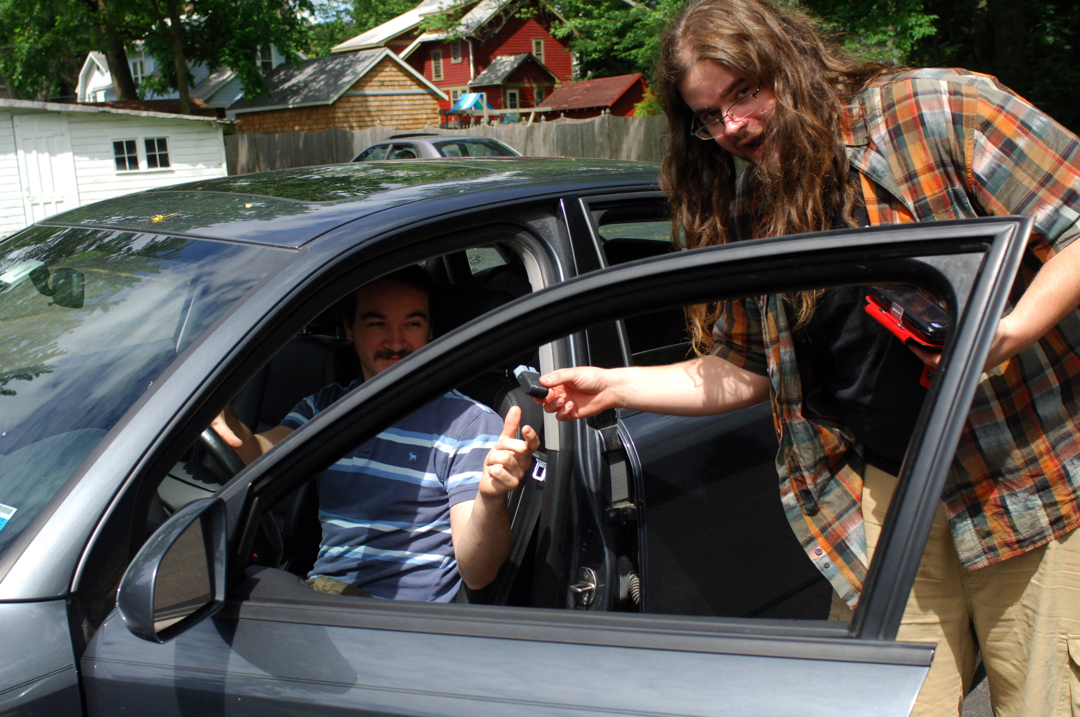 matt and nick outside car with obd2 bluetooth dongle and windows phone